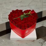 Arranged with 25 Red Roses, Baby Breath and Leaves Breath in a Heart Box
