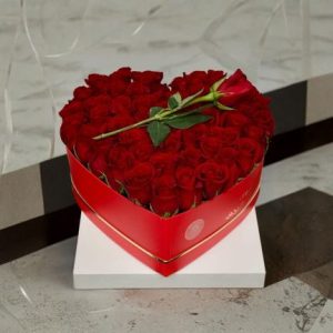 Arranged with 25 Red Roses, Baby Breath and Leaves Breath in a Heart Box